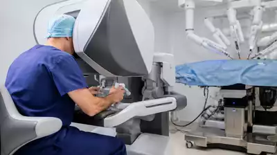 User interacting with robotic surgery equipment